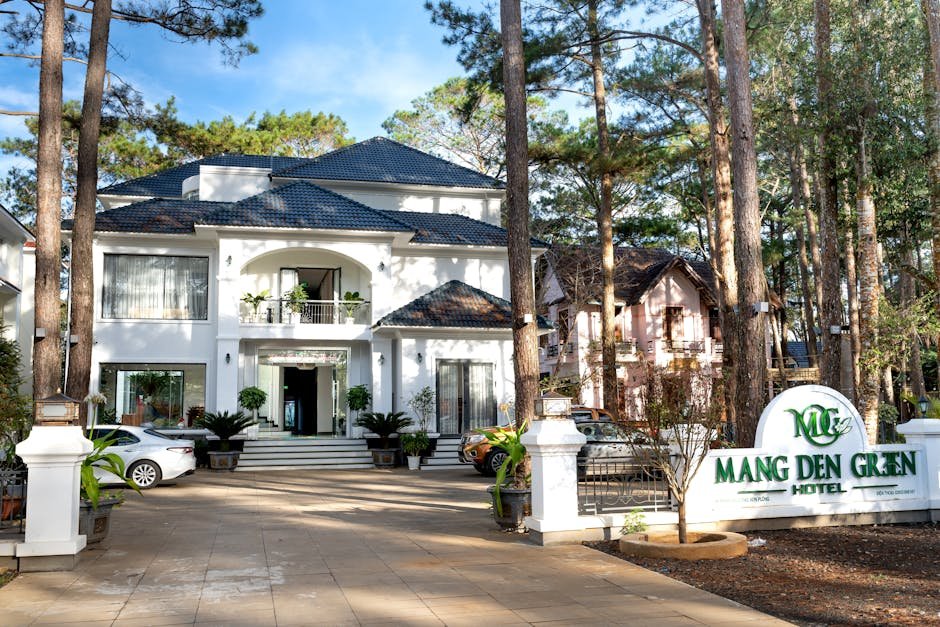 Beautiful entrance of Mang Den Green Hotel surrounded by serene forest. Ideal for luxury stays.